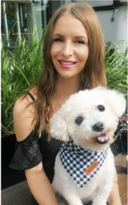 Happy and healthy relaxed smiling woman with her cute fluffy white calm dog