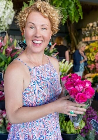 Natural Therapies for Pets Woman holding pink roses in front of florist shop