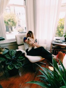 woman and dog healthy and happy with plants at home